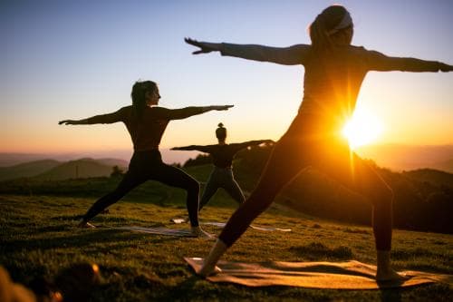 Yoga Class Held at Sunset on Mountaintop Yoga Class Held at Sunset on Mountaintop