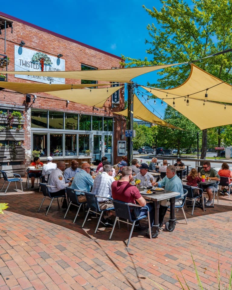Twisted Laurel Downtown Asheville's dog-friendly patio across from iconic Pack Square Park, perfect for enjoying an amazing meal while people-watching and sitting in the sunshine. Twisted Laurel Downtown Asheville's dog-friendly patio across from iconic Pack Square Park, perfect for enjoying an amazing meal while people-watching and sitting in the sunshine.